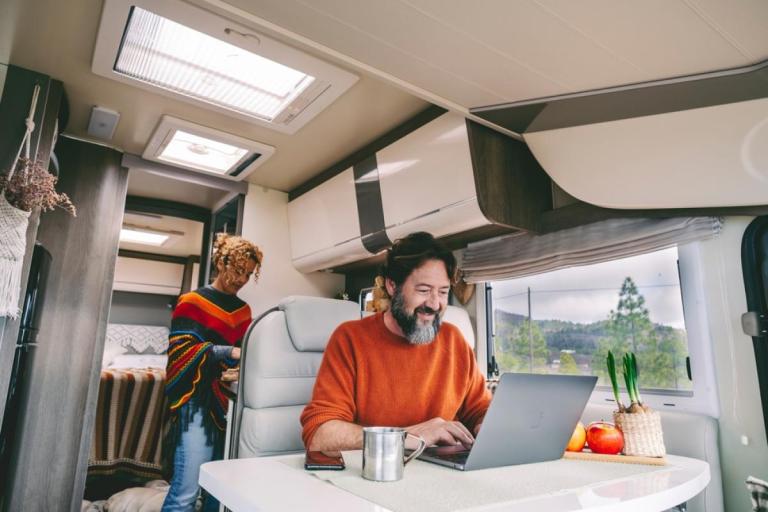 Man using a laptop inside an RV