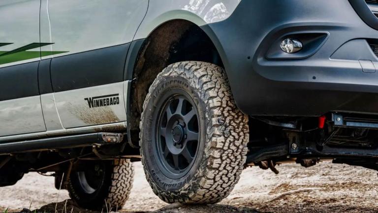 Close up view of tires that have driven through mud on a Winnebago campervan