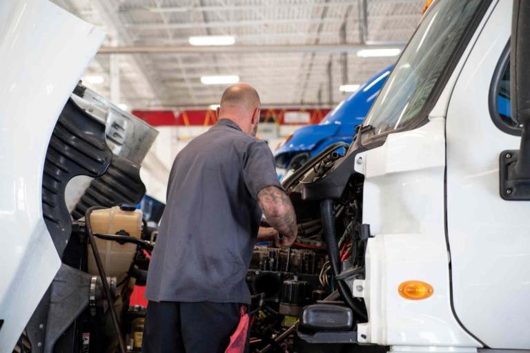 Man working on a commercial truck engine