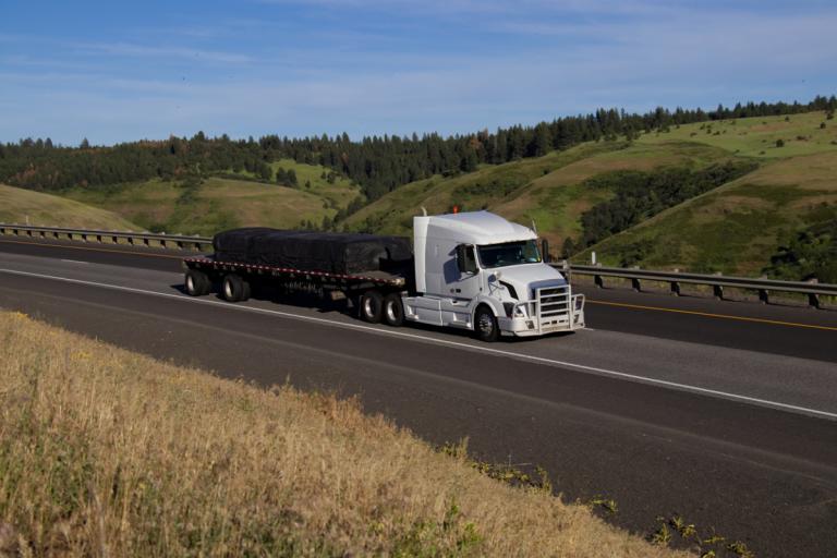 Semi pulling flatbed trailer