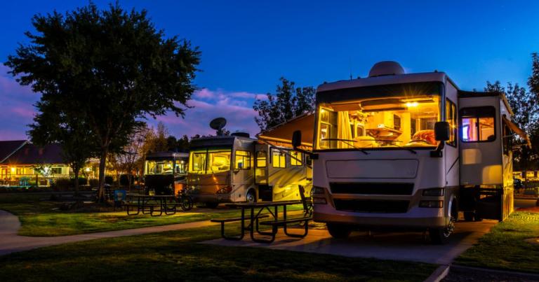 RVs parked in a campground at dusk