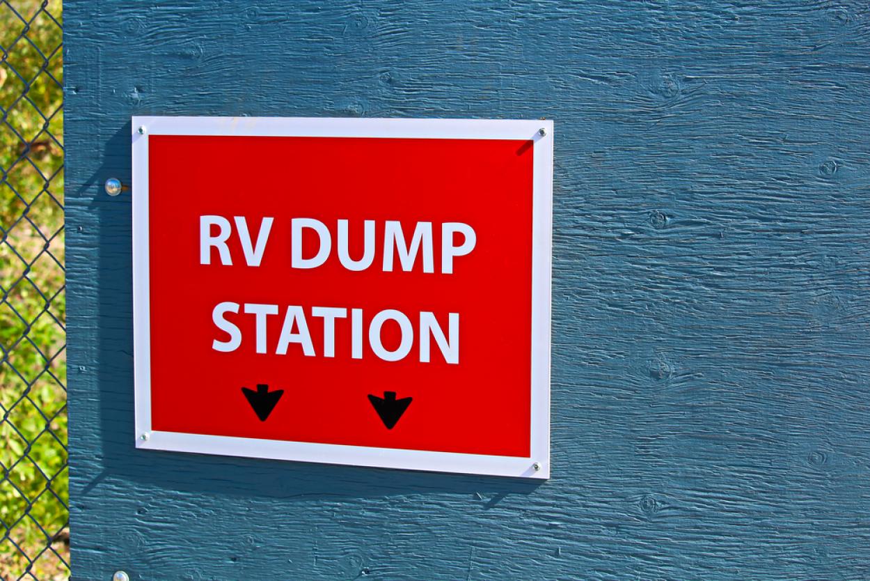 Image of a large red sign that reads, "RV DUMP STATION"