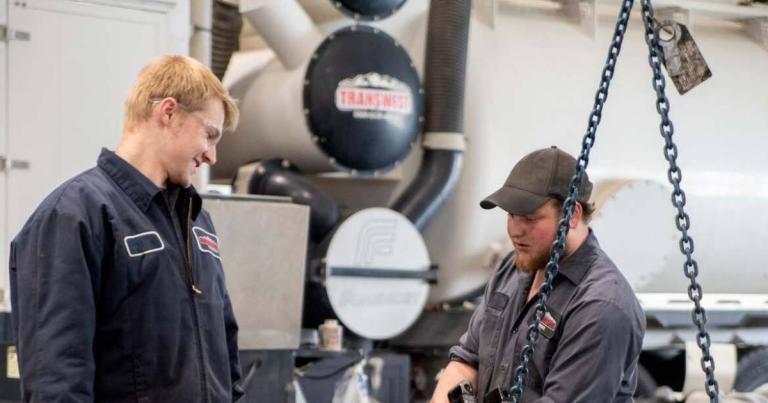 Two diesel technicians working together in a shop