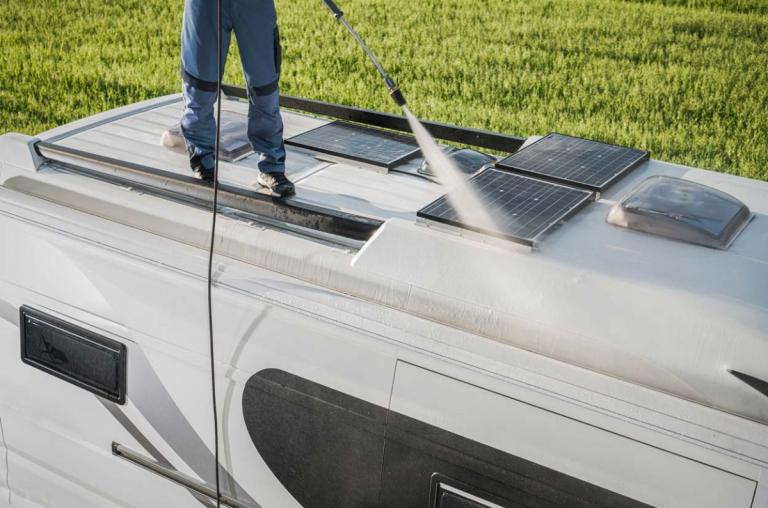 Man cleaning roof of an RV