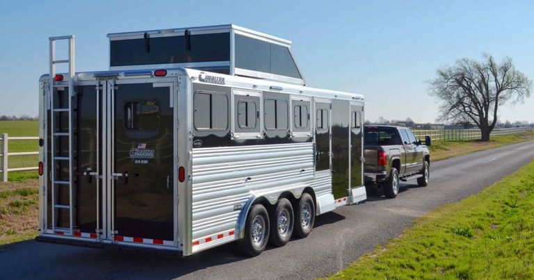 Black Cimarron bumper pull trailer being towed by a pickup truck