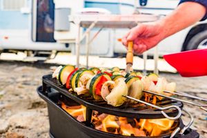 Outdoor grill with an RV in the background