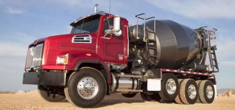 Cement mixer truck parked on sand