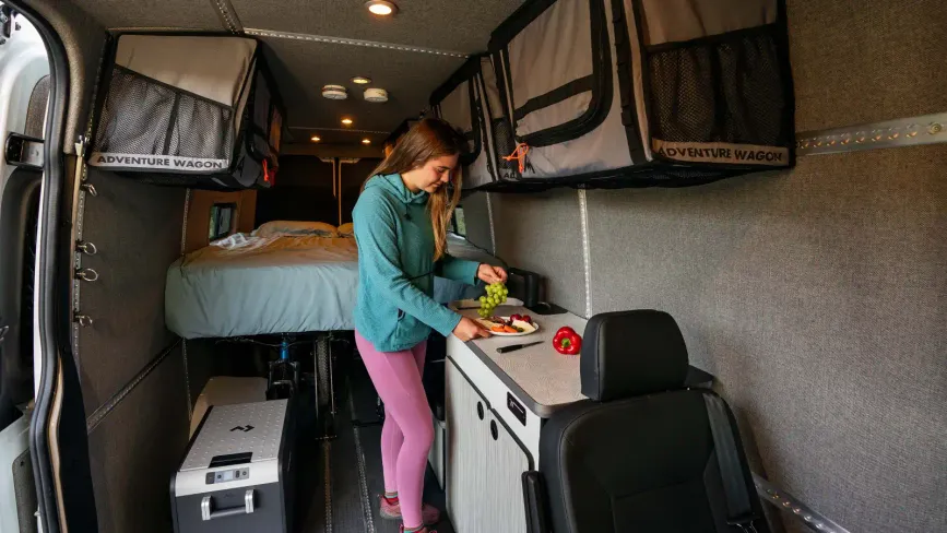 Person cooking inside the Adventure wagon