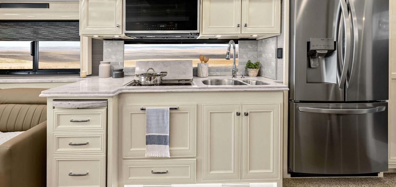 An interior shot of the kitchen area inside of a Tiffin RV