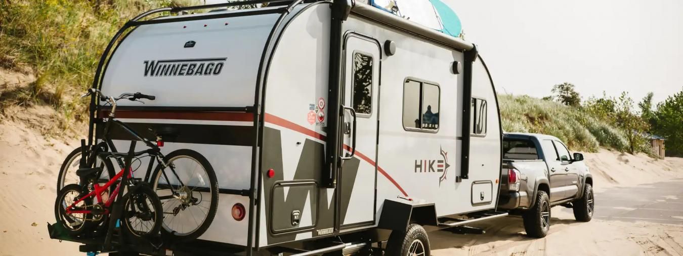 A truck hauling a Winnebago RV trailer