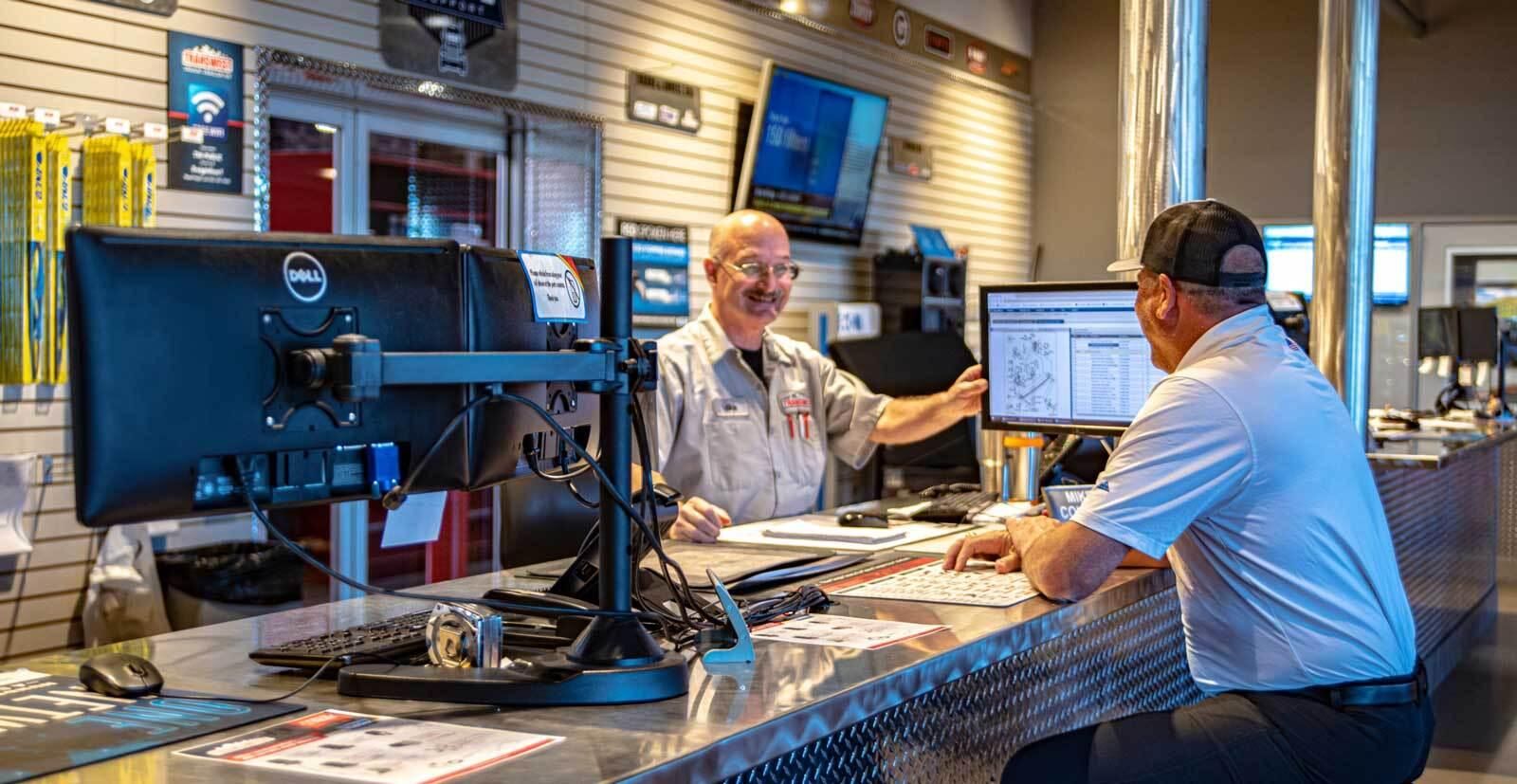 Two men at Trailers Parts counter