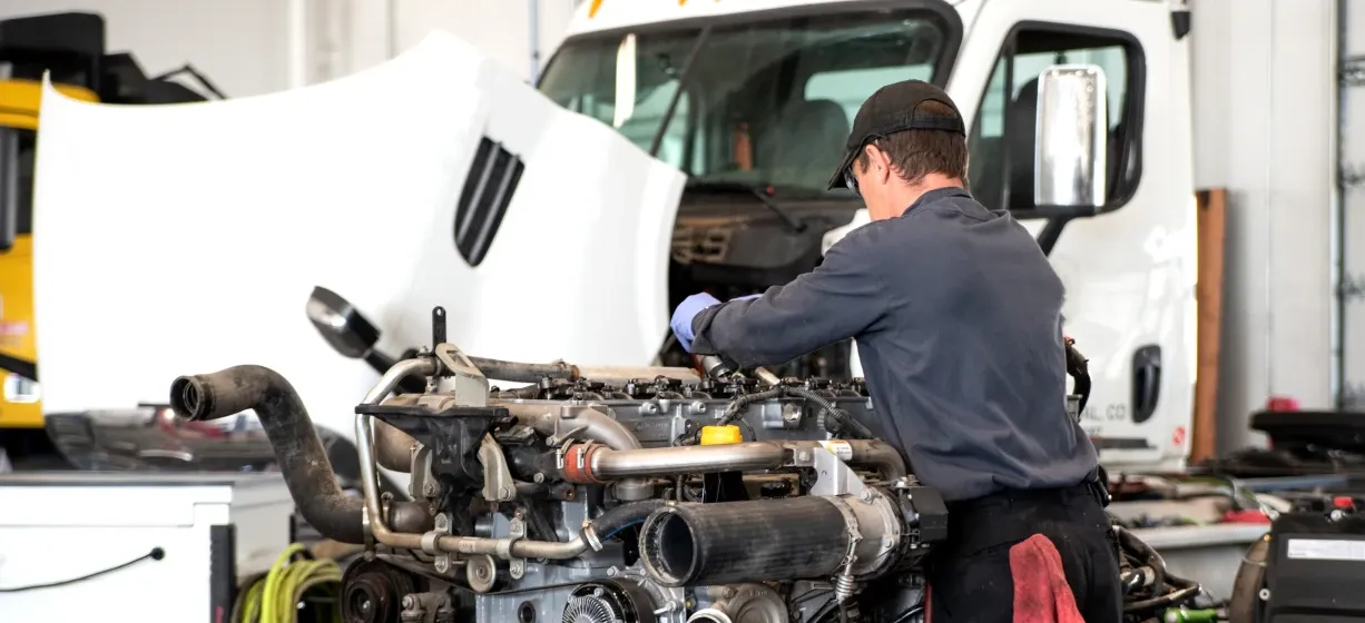 A man servicing a commercial truck