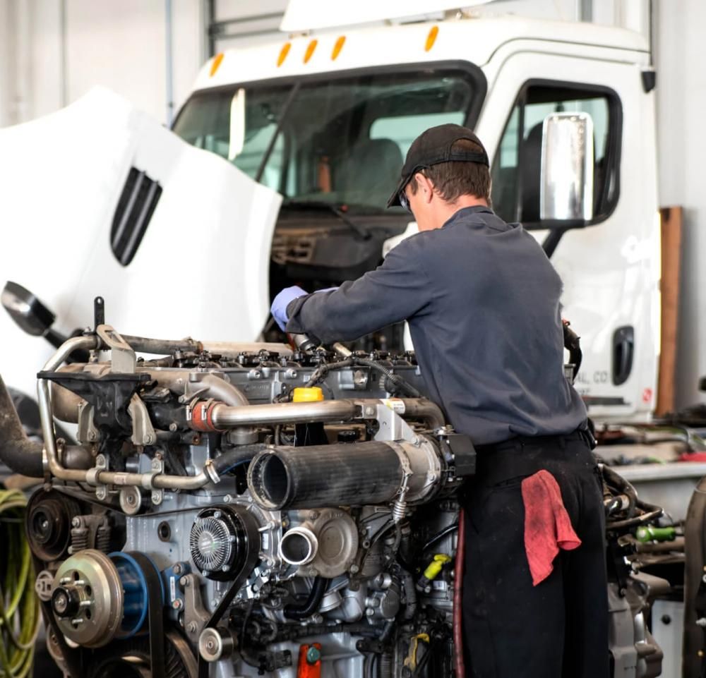 A mechanic working on an engine block