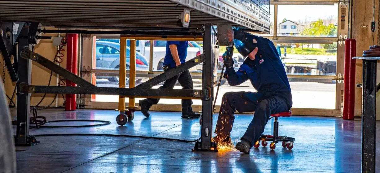 A technician servicing a trailer