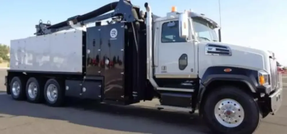 A black and white hydrovac truck