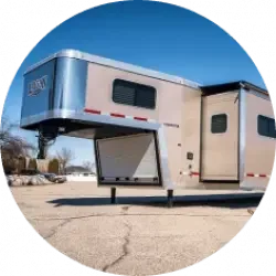 An unattached livestock trailer in an empty lot